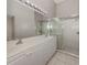 Bright bathroom featuring a double sink vanity, a large mirror, and glass enclosed shower at 4153 Fairway Dr, North Port, FL 34287
