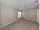 Cozy bedroom featuring neutral colored walls, carpet, and a ceiling fan for comfort at 4153 Fairway Dr, North Port, FL 34287