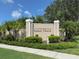 Elegant 'Villas of Sabal Trace' sign with lush landscaping adding to the community's curb appeal at 4153 Fairway Dr, North Port, FL 34287