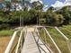 Wooden boardwalk over the water, surrounded by lush foliage and greenery at 4153 Fairway Dr, North Port, FL 34287