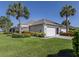 Charming single-story home with a two-car garage and tropical landscaping at 4153 Fairway Dr, North Port, FL 34287
