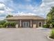 Well-maintained building with double door entrance, complemented by professional landscaping and ample parking at 4153 Fairway Dr, North Port, FL 34287