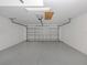Clean two car garage with a metal garage door and white walls, spacious for parking and storage at 4153 Fairway Dr, North Port, FL 34287