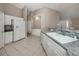 Bright eat-in kitchen boasting white cabinets, tile floors, and marble countertops at 4153 Fairway Dr, North Port, FL 34287