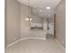Bright kitchen with vaulted ceilings, white appliances, and decorative lighting at 4153 Fairway Dr, North Port, FL 34287