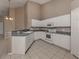 Open kitchen features modern appliances, white cabinets, and lots of light at 4153 Fairway Dr, North Port, FL 34287