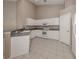 Well-lit kitchen showcasing modern appliances, tile flooring, and white cabinets at 4153 Fairway Dr, North Port, FL 34287