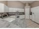 Modern kitchen with white appliances, cabinetry, and tile flooring at 4153 Fairway Dr, North Port, FL 34287
