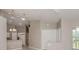Open living space with high ceilings, an adjacent kitchen, and a view of the backyard at 4153 Fairway Dr, North Port, FL 34287