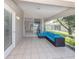 Relaxing screened-in patio with tile flooring and comfortable outdoor seating and an outdoor view at 4153 Fairway Dr, North Port, FL 34287