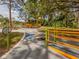 Community playground features a variety of inclusive structures, colorful ramps, and sunshades at 4153 Fairway Dr, North Port, FL 34287