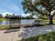 Relaxing lakeside setting with benches under a shaded tree, offering a peaceful outdoor retreat at 4153 Fairway Dr, North Port, FL 34287