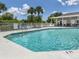 Refreshing community pool with ladder access, surrounded by seating and a convenient pool house at 4153 Fairway Dr, North Port, FL 34287