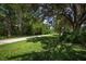 A long walking path runs through an outdoor recreational area with grassy expanses and large trees at 4153 Fairway Dr, North Port, FL 34287