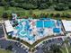 An aerial view of the expansive community water park, featuring vibrant pools, slides, and recreational areas for all at 4153 Fairway Dr, North Port, FL 34287