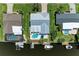Aerial view of a waterfront home featuring a pool, a dock with boats, and lush landscaping at 4508 Mangrove Point Rd, Bradenton, FL 34210