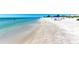 Calm daytime view of clear, shallow water meeting a white sandy beach at 4508 Mangrove Point Rd, Bradenton, FL 34210