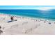 Beautiful view of a sunny beach with clear blue water and volleyball nets on the white sand at 4508 Mangrove Point Rd, Bradenton, FL 34210