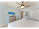 Bright bedroom with a dresser that holds a TV and a closet at 4508 Mangrove Point Rd, Bradenton, FL 34210