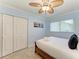 Comfortable bedroom with tile floors, light blue walls and a window overlooking the backyard at 4508 Mangrove Point Rd, Bradenton, FL 34210