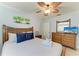 Comfortable bedroom featuring a ceiling fan, beach-themed decor, and wood furniture at 4508 Mangrove Point Rd, Bradenton, FL 34210