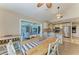 Bright dining area featuring tile floors, a wooden table, and a view into the living room and kitchen at 4508 Mangrove Point Rd, Bradenton, FL 34210