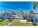 Dock with boat features a well-maintained lawn, lush tropical landscaping, and a private dock on the canal at 4508 Mangrove Point Rd, Bradenton, FL 34210
