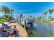 Dock featuring a boat lift showcases waterfront living and recreational opportunities at 4508 Mangrove Point Rd, Bradenton, FL 34210