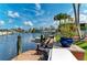 Dock on the canal features a seating area and lush tropical landscaping at 4508 Mangrove Point Rd, Bradenton, FL 34210