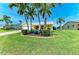 Charming single-story home with lush lawn, palm trees, and a welcoming front porch at 4508 Mangrove Point Rd, Bradenton, FL 34210