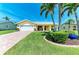 Charming single-story home with lush lawn, palm trees, and a welcoming front porch at 4508 Mangrove Point Rd, Bradenton, FL 34210