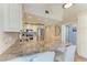 Open-concept kitchen with a breakfast bar, granite counters and stainless steel appliances at 4508 Mangrove Point Rd, Bradenton, FL 34210