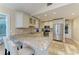 Bright kitchen featuring stainless steel appliances, granite counters and white cabinetry at 4508 Mangrove Point Rd, Bradenton, FL 34210
