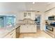Modern kitchen with granite countertops, stainless steel appliances and views of the pool at 4508 Mangrove Point Rd, Bradenton, FL 34210