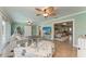 Bright living room with neutral decor, tile floors and views of the front entryway and other rooms at 4508 Mangrove Point Rd, Bradenton, FL 34210