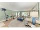 Comfortable living room featuring tiled floors, plush seating, and large windows offering natural light at 4508 Mangrove Point Rd, Bradenton, FL 34210