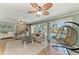 Open-concept living room with hanging chair, sofa and views to the outdoor pool area through sliding glass doors at 4508 Mangrove Point Rd, Bradenton, FL 34210