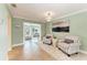 Open living room with tile floors, striped chairs, and natural light flowing to the adjacent rooms at 4508 Mangrove Point Rd, Bradenton, FL 34210