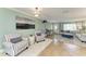 Open living room with tile floors, striped chairs, and natural light flowing to the adjacent rooms at 4508 Mangrove Point Rd, Bradenton, FL 34210