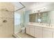 Well-lit bathroom with a walk-in shower, tiled walls, and double sink vanity at 4508 Mangrove Point Rd, Bradenton, FL 34210