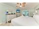 Well-lit bedroom with views into the living room featuring a queen bed and coastal themed decor at 4508 Mangrove Point Rd, Bradenton, FL 34210