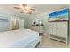 Comfortable bedroom featuring tile flooring, coastal decor, and a view into the bathroom at 4508 Mangrove Point Rd, Bradenton, FL 34210