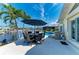 Inviting patio with a grill, dining area and views of the canal at 4508 Mangrove Point Rd, Bradenton, FL 34210