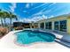 Pool area features an in-ground pool, spa, and covered patio with views of the backyard and house at 4508 Mangrove Point Rd, Bradenton, FL 34210