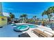 Outdoor pool and hot tub surrounded by palm trees and overlooking a canal at 4508 Mangrove Point Rd, Bradenton, FL 34210