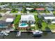 Aerial view of a waterfront home with a pool, dock, and boat, surrounded by lush landscaping and canal views at 4508 Mangrove Point Rd, Bradenton, FL 34210