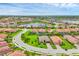 Beautiful aerial view of a Primary-planned community with lush landscaping, a serene lake, and well-maintained homes at 4524 Baltry Ct, Bradenton, FL 34211