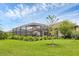 Serene backyard showcasing a screened-in pool, and vibrant landscaping at 4524 Baltry Ct, Bradenton, FL 34211
