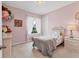 Cozy bedroom with pink walls, plush carpet, and a view of the front yard at 4524 Baltry Ct, Bradenton, FL 34211