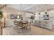 Elegant dining room adjacent to kitchen boasts stylish table and chandelier, open concept at 4524 Baltry Ct, Bradenton, FL 34211